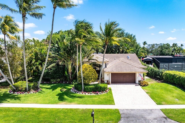 4590 Live Oak Blvd, Delray Beach, FL 33445 - view of front of home featuring decorative driveway, a garage, a front lawn, and stucco siding