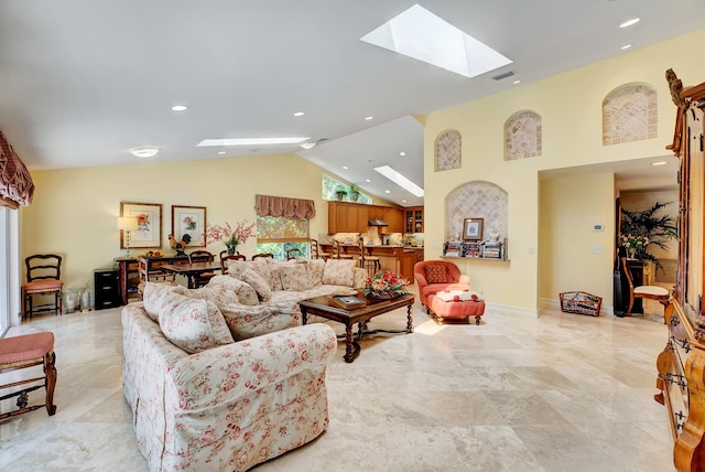 living room featuring a skylight, light tile floors, and high vaulted ceiling