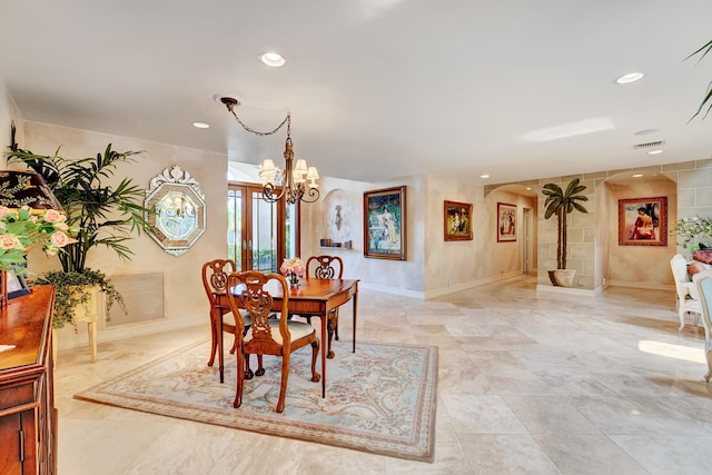 tiled dining space with an inviting chandelier