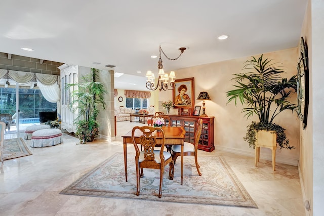 dining space featuring an inviting chandelier and light tile floors