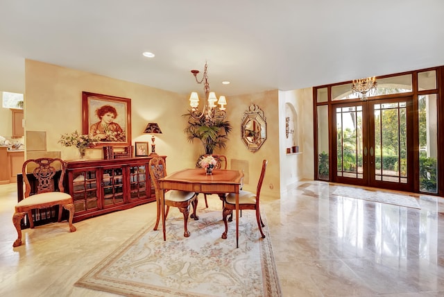 dining space with light tile floors, a chandelier, and french doors