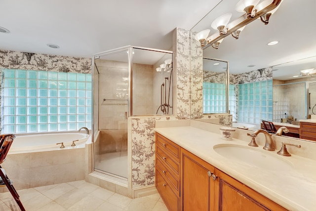 bathroom with shower with separate bathtub, tile floors, and vanity with extensive cabinet space