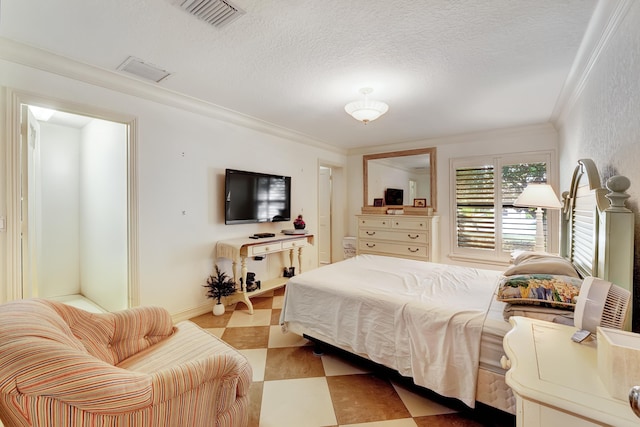 bedroom with crown molding, a textured ceiling, and light tile flooring