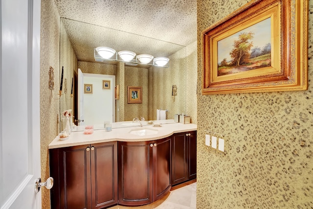 bathroom with tile floors, a textured ceiling, and vanity