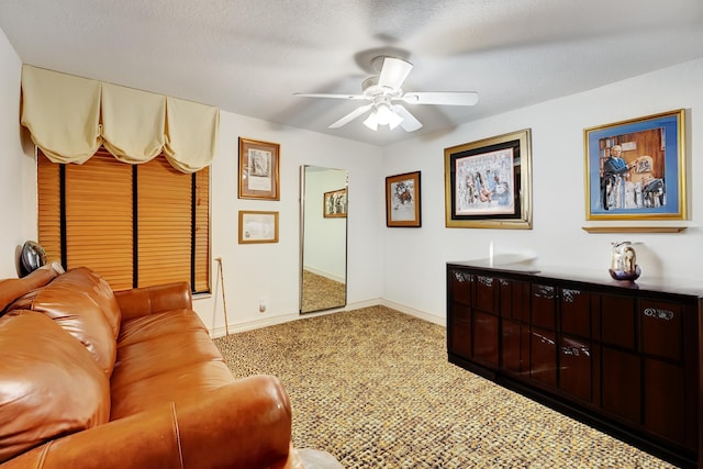 carpeted living room with a textured ceiling and ceiling fan