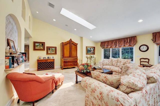 tiled living room with a skylight and high vaulted ceiling