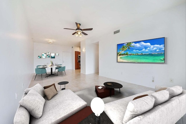 tiled living room featuring ceiling fan