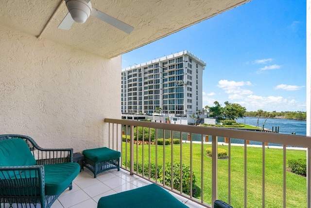 balcony featuring a water view and ceiling fan