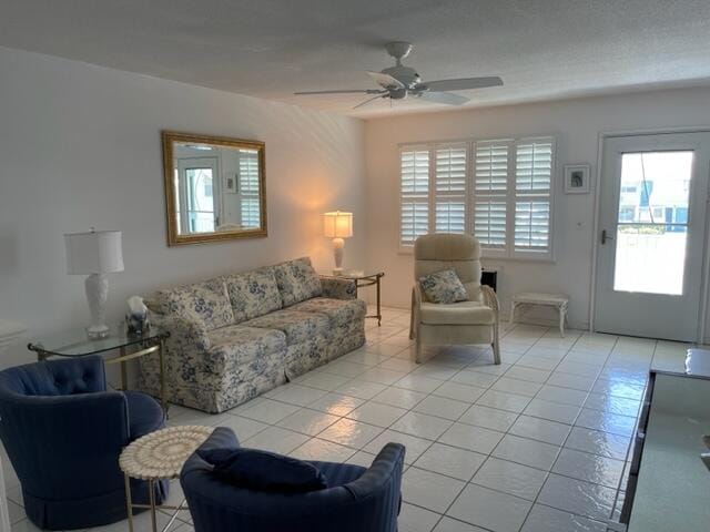 tiled living room featuring ceiling fan