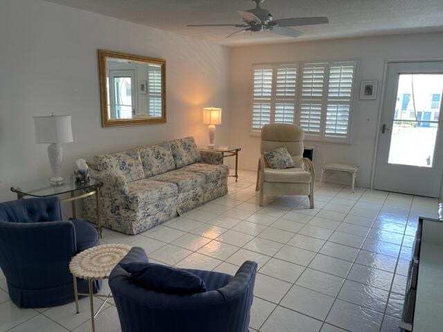 tiled living room with ceiling fan