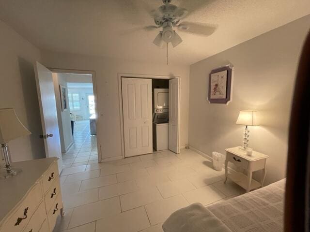 unfurnished bedroom featuring ceiling fan, a closet, and light tile floors