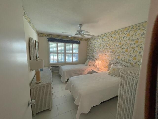 bedroom with light tile flooring and ceiling fan