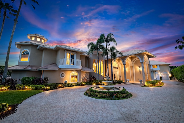 mediterranean / spanish-style house with a balcony and a garage