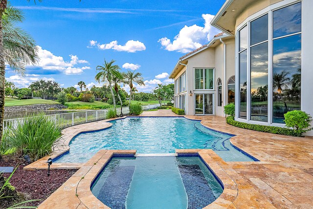 view of pool with an in ground hot tub and a patio area