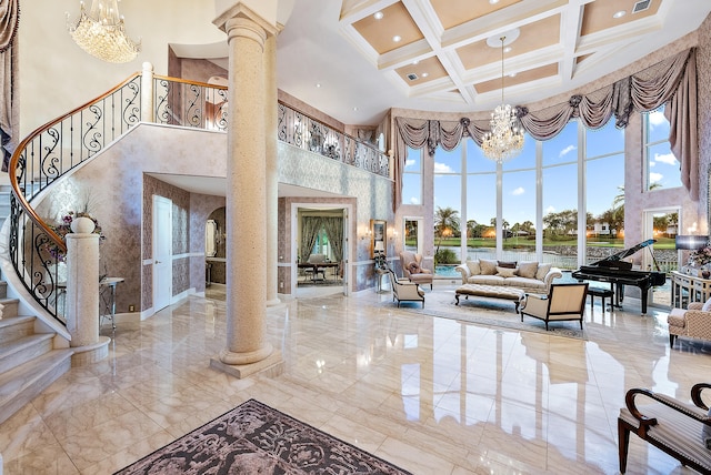 interior space featuring light tile floors, decorative columns, coffered ceiling, a high ceiling, and a notable chandelier