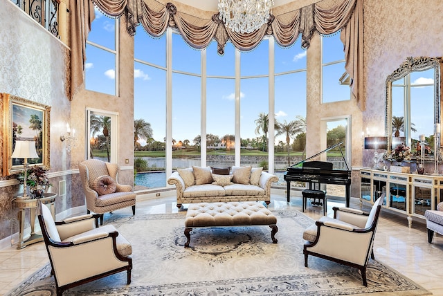 interior space with plenty of natural light, a chandelier, and a towering ceiling