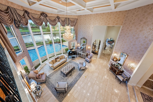 tiled living room with beam ceiling, coffered ceiling, a notable chandelier, and a high ceiling