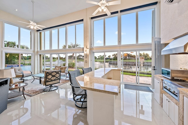 sunroom / solarium with ceiling fan