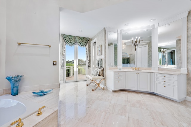 bathroom featuring tile flooring, a bathtub, vanity, and an inviting chandelier