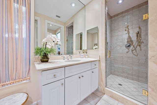 bathroom with a shower with door, tile floors, and oversized vanity