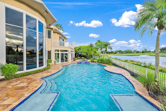 view of swimming pool with a water view and a patio