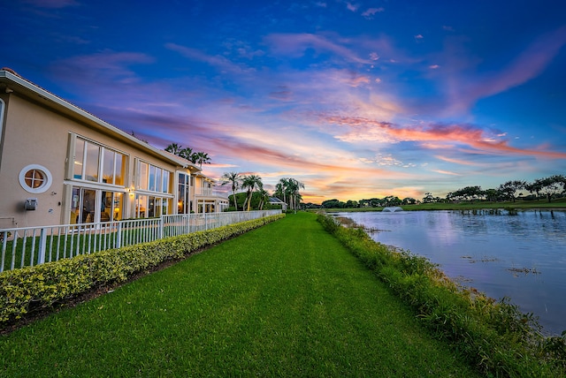 yard at dusk with a water view