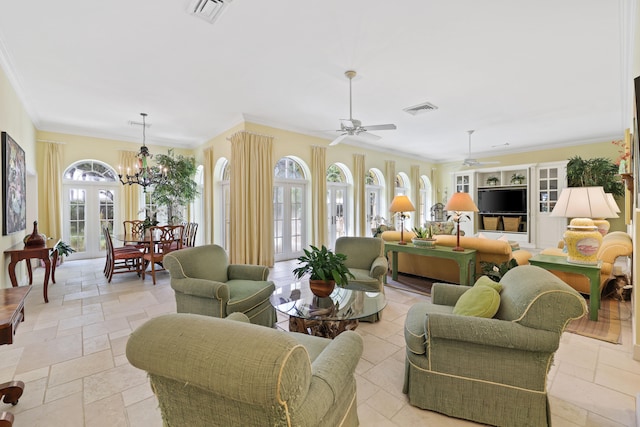 living room featuring ornamental molding, light tile floors, and ceiling fan with notable chandelier