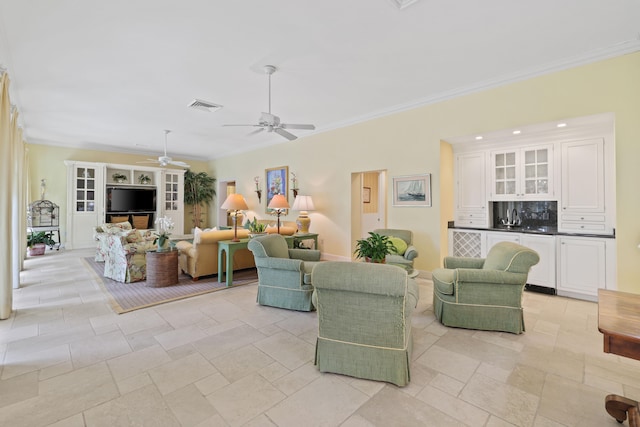 living room featuring light tile floors, ceiling fan, and crown molding