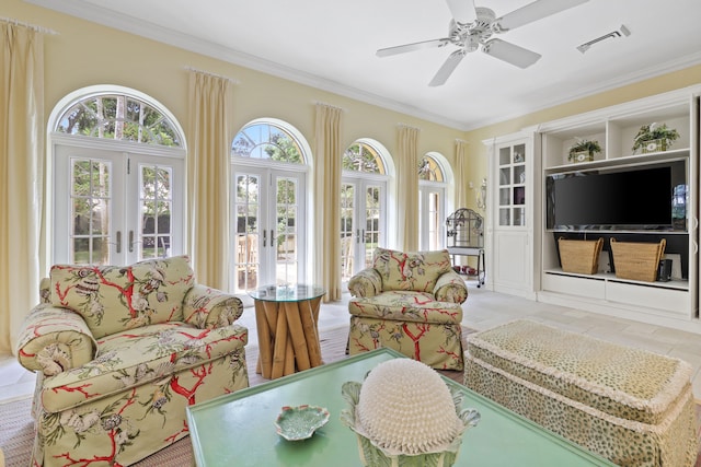 sunroom featuring ceiling fan and french doors