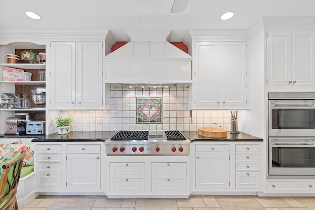 kitchen featuring white cabinetry, premium range hood, appliances with stainless steel finishes, and light tile floors