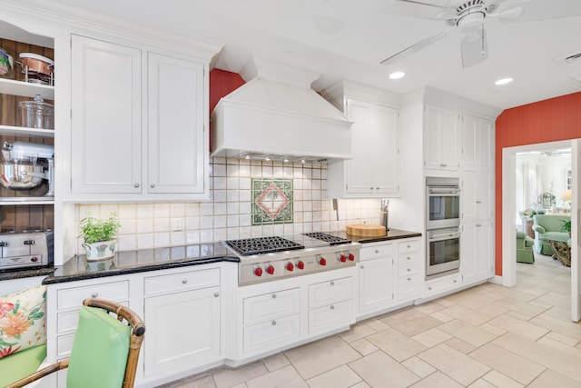 kitchen featuring appliances with stainless steel finishes, white cabinetry, custom exhaust hood, and ceiling fan