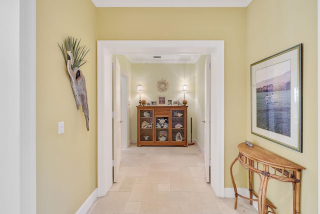 hall featuring ornamental molding and light tile flooring