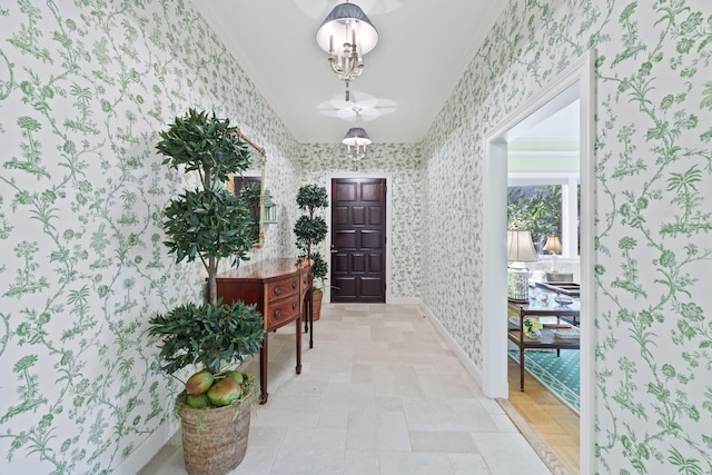 doorway featuring light tile flooring and ornamental molding