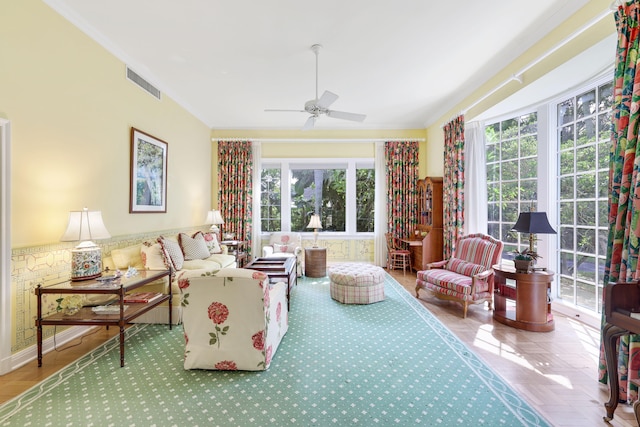 living room with crown molding and ceiling fan