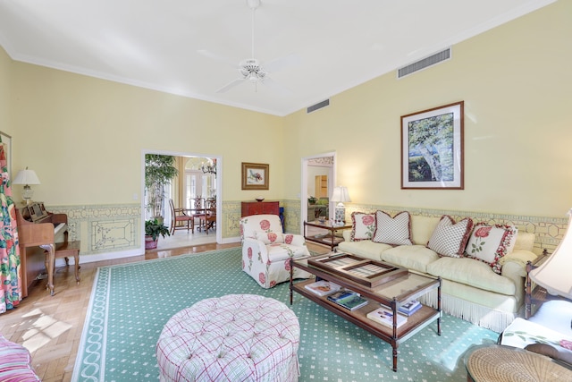 living room with ceiling fan and crown molding