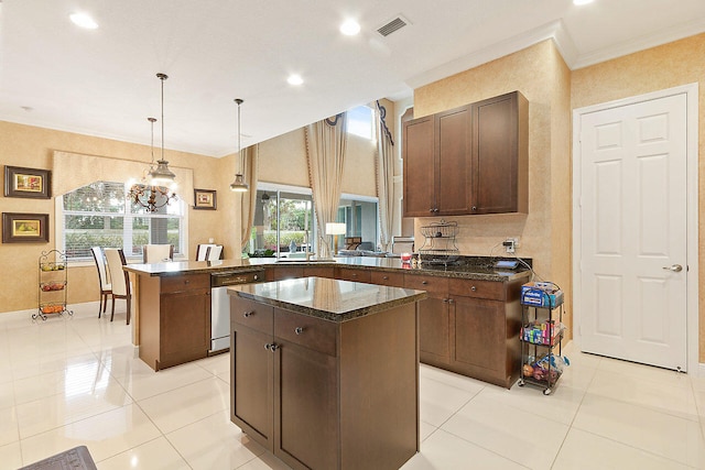 kitchen featuring a kitchen island, pendant lighting, dishwasher, and a notable chandelier