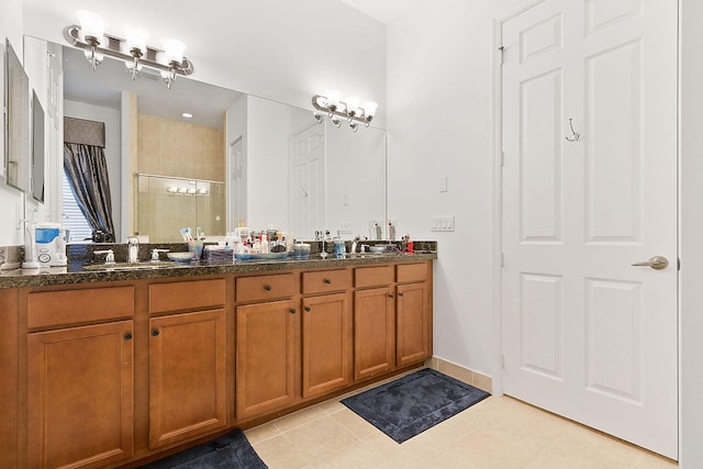 bathroom with double vanity and tile floors