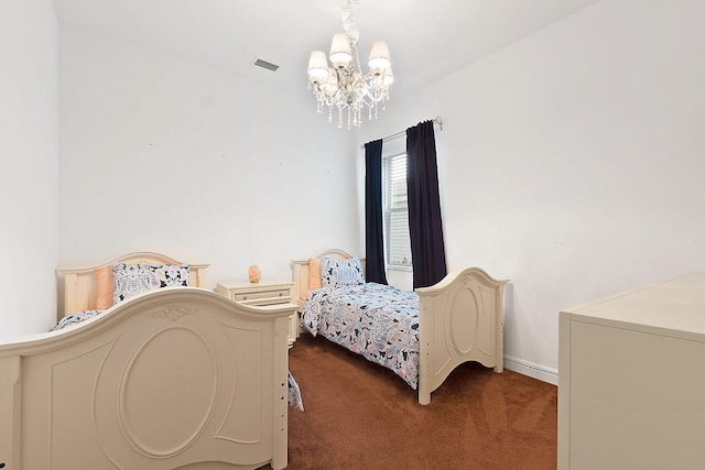 carpeted bedroom with an inviting chandelier