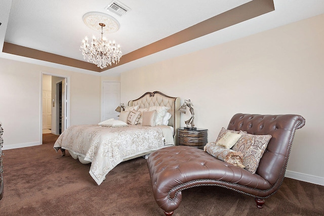 bedroom featuring dark carpet, a chandelier, and a raised ceiling