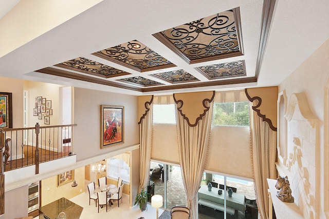 interior space with a chandelier and coffered ceiling