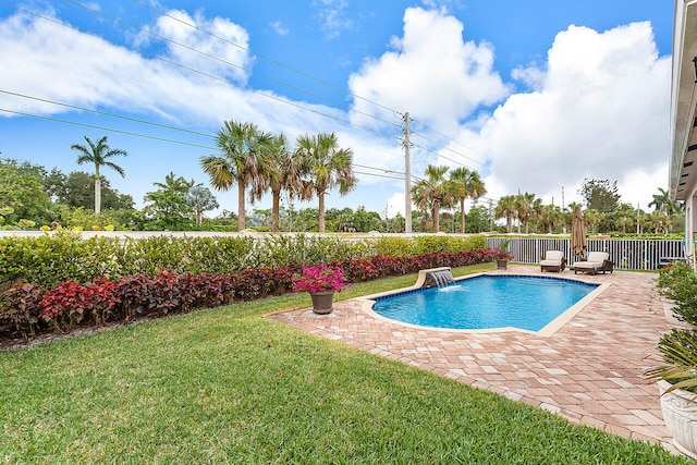 view of swimming pool with a patio, a yard, and pool water feature