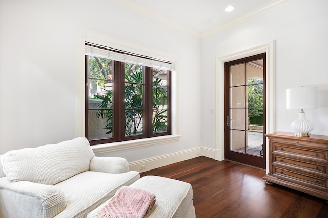 sitting room featuring crown molding and dark hardwood / wood-style flooring