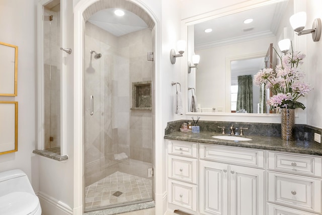 bathroom featuring walk in shower, toilet, ornamental molding, and vanity