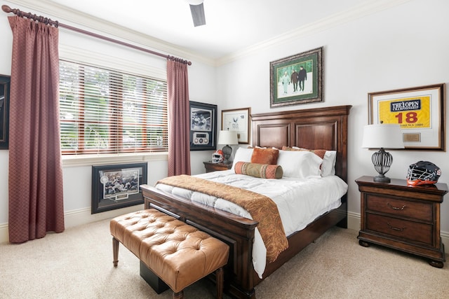 carpeted bedroom featuring crown molding and ceiling fan