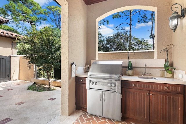 view of terrace with area for grilling, sink, and exterior kitchen