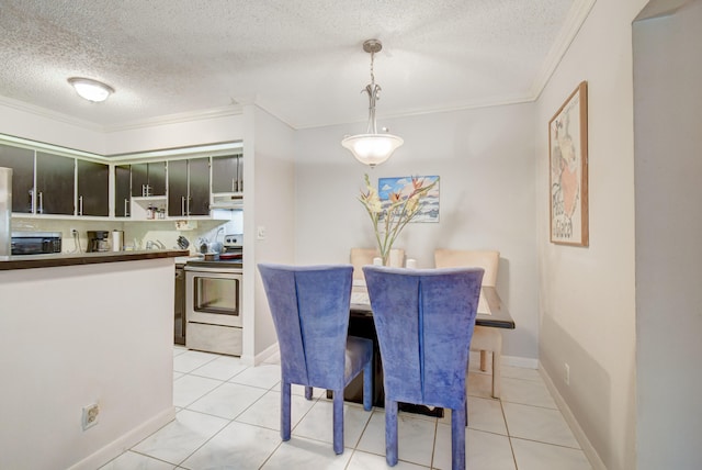 tiled dining room with a textured ceiling and crown molding