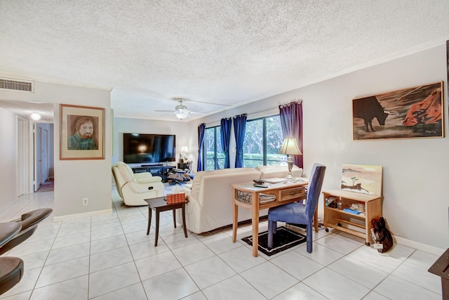 tiled dining space with ceiling fan and a textured ceiling