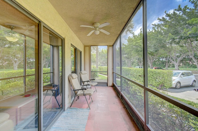 unfurnished sunroom featuring ceiling fan