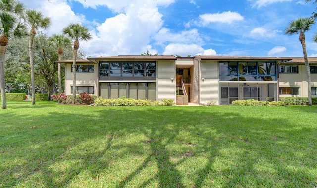 back of house with a lawn