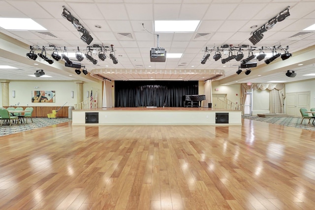 miscellaneous room featuring a paneled ceiling and hardwood / wood-style floors